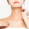 A woman has skincare on her neck.