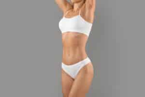 Woman enjoying smooth liposuction recovery in Worcester, MA