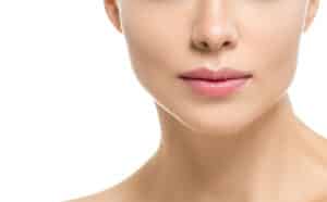 Woman with enhanced lips after lip augmentation treatment.