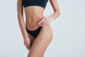 Woman's lower body showing thigh and buttock contours after body contouring surgery.