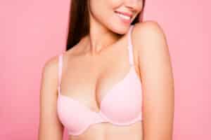 Woman showcasing breast appearance after breast lift and breast augmentation surgery.