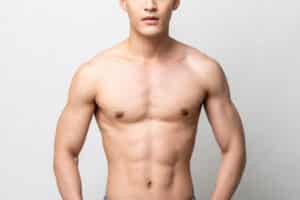 Man with a toned chest after male breast reduction recovery.