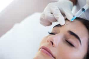Botox injection treatment on a woman’s face at a cosmetic clinic.